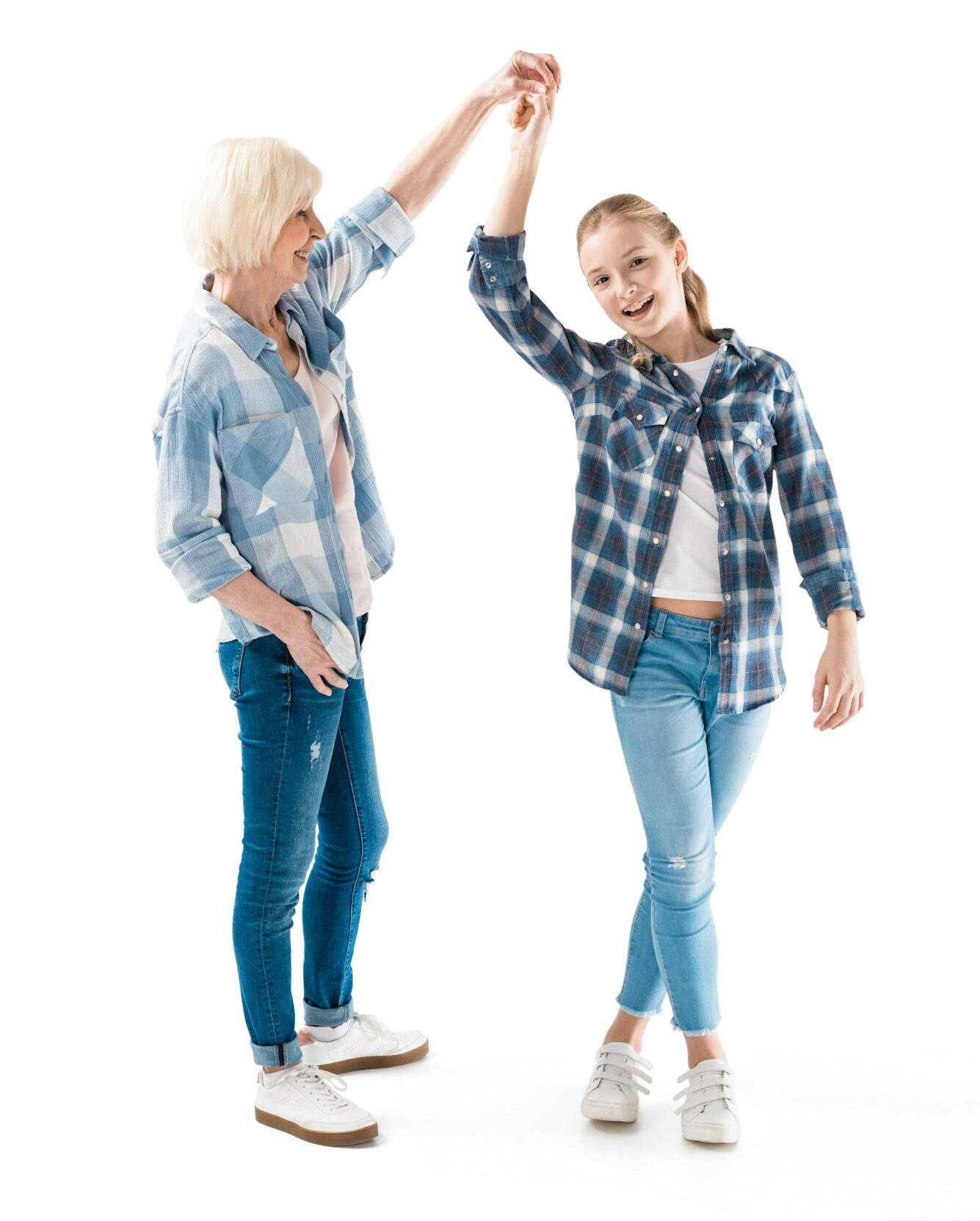 happy grandchild dancing with grandmother isolated on white in studio